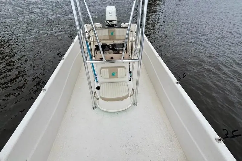 Slide: The Image of 2017 Carolina Skiff 238 DLV boat on water, featuring center console and seating. - 9