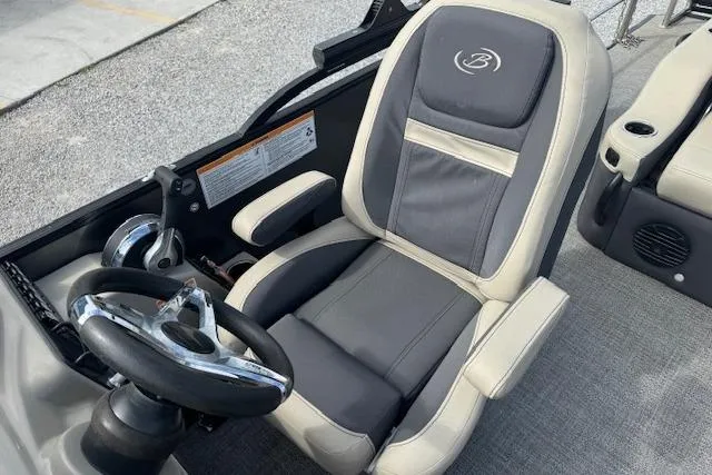 Slide: The Image of 2022 Barletta Cabrio 22UC boat interior with steering wheel and captain's chair. - 14