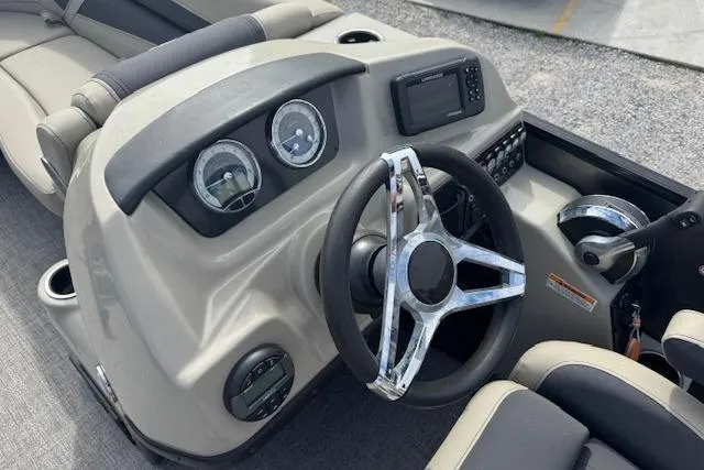 Slide: The Image of 2022 Barletta Cabrio 22UC boat dashboard with steering wheel and gauges. - 15