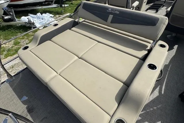 Slide: The Image of 2022 Barletta Cabrio 22UC boat seating with cup holders, beige upholstery, and sleek design. - 19