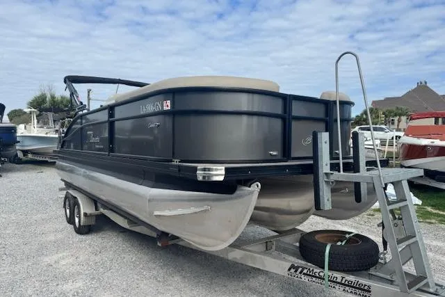Slide: The Image of 2022 Barletta Cabrio 22UC pontoon boat on trailer, parked outdoors. - 4