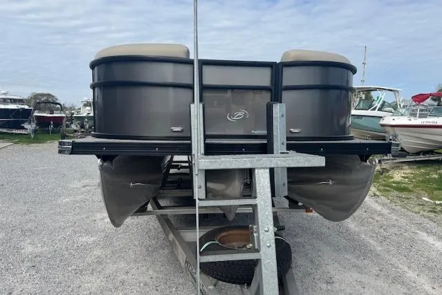 Slide: The Image of 2022 Barletta Cabrio 22UC pontoon boat on trailer, parked outdoors. - 5