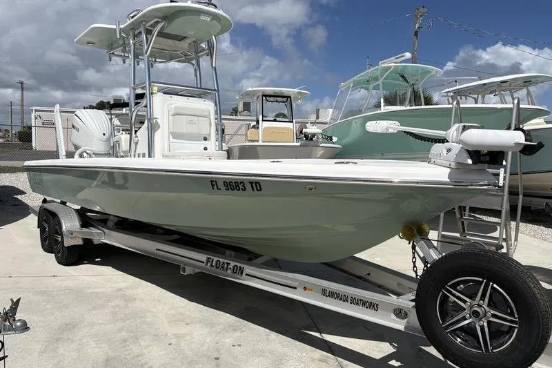 The Image of 2022 Islamorada 24 Morada boat on trailer, parked outdoors under blue sky. - 1