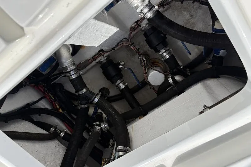 Slide: The Image of Engine compartment of 2022 Islamorada 24 Morada boat, showcasing hoses and wiring. - 12