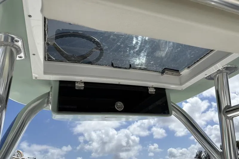 Slide: The Image of 2022 Islamorada 24 Morada boat console with steering wheel, under a clear sky. - 20