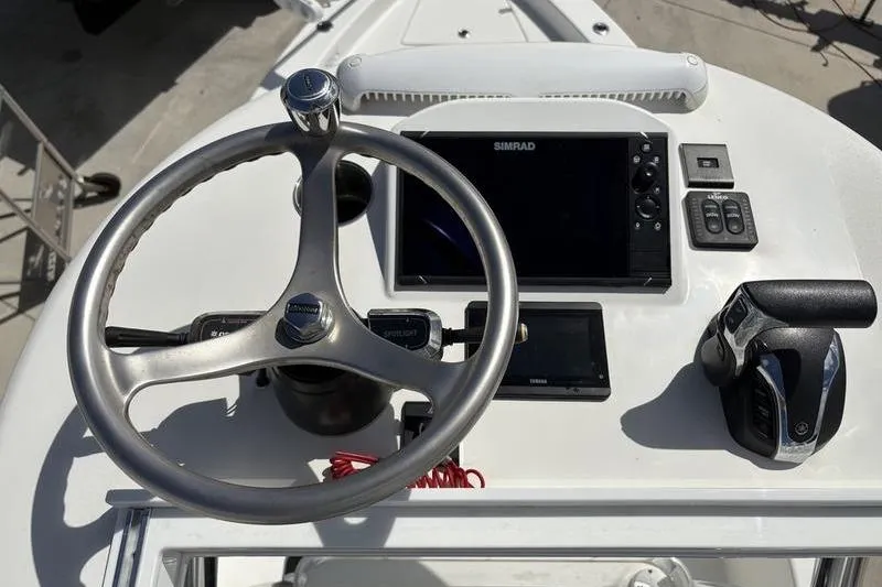 Slide: The Image of Steering console of 2022 Islamorada 24 Morada boat with Simrad display and controls. - 22