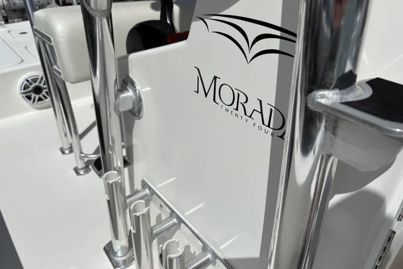Slide: The Image of 2022 Islamorada 24 Morada boat interior with logo and chrome details. - 23