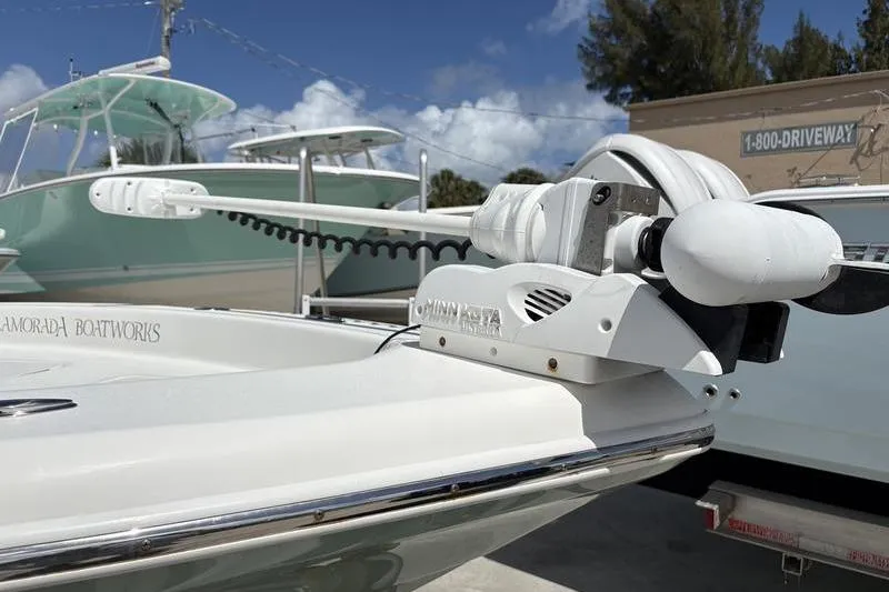 Slide: The Image of 2022 Islamorada 24 Morada boat with Minn Kota trolling motor, parked outdoors. - 26