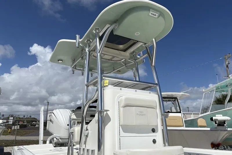 Slide: The Image of 2022 Islamorada 24 Morada boat with T-top under a clear blue sky. - 3