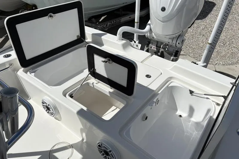 Slide: The Image of 2022 Islamorada 24 Morada boat with open storage compartments and motor. - 6