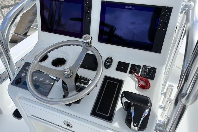 Slide: The Image of 2022 Islamorada 24 Morada boat dashboard with steering wheel and navigation screens. - 7