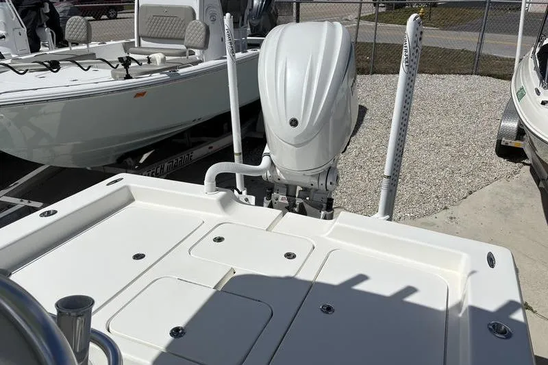 Slide: The Image of 2022 Islamorada 24 Morada boat with outboard motor, displayed in a marina setting. - 9