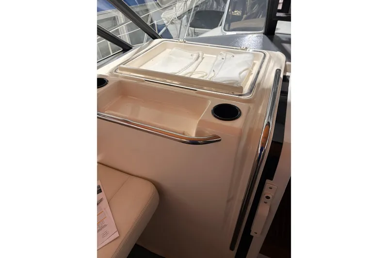 Slide: The Image of 1994 Tiara Yachts 3100 Open interior with seating and storage, showcasing classic design. - 12