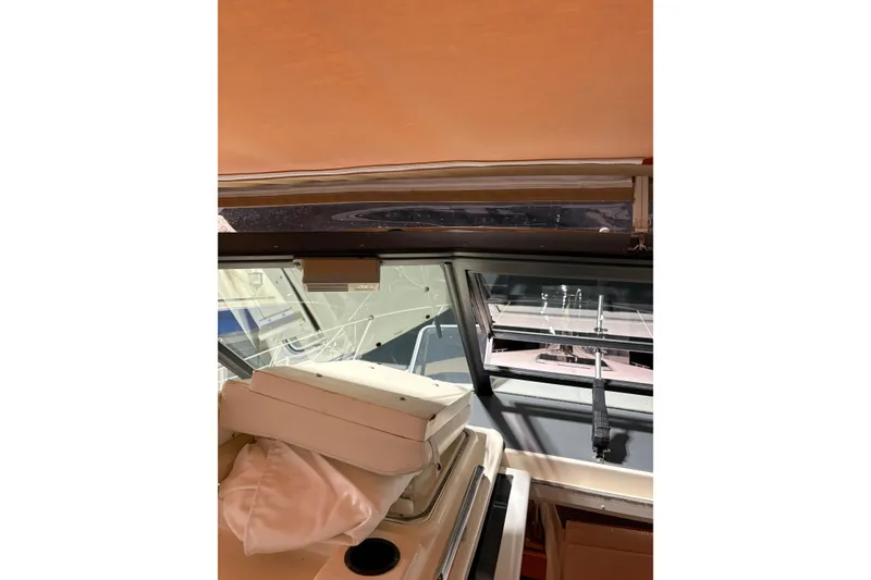 Slide: The Image of 1994 Tiara Yachts 3100 Open interior with white seating and yellow cable. - 15