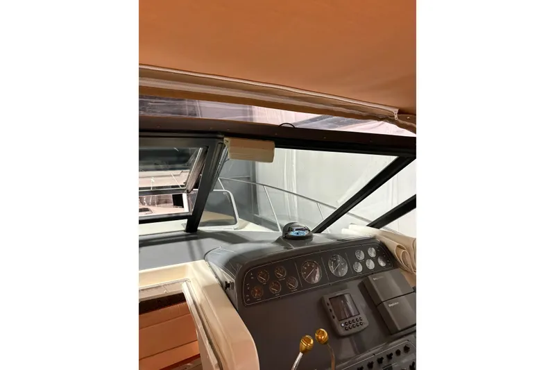 Slide: The Image of 1994 Tiara Yachts 3100 Open cockpit detail with storage and cup holders. - 16