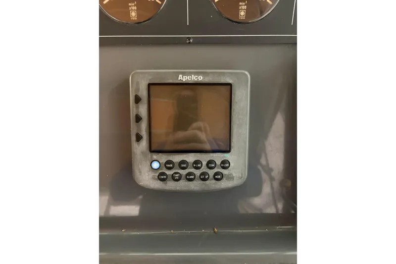 Slide: The Image of 1994 Tiara Yachts 3100 Open interior with storage compartment and seating area. - 18