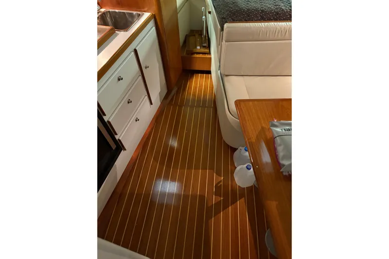 Slide: The Image of Control panel of a 1994 Tiara Yachts 3100 Open, featuring switches and steering wheel. - 23