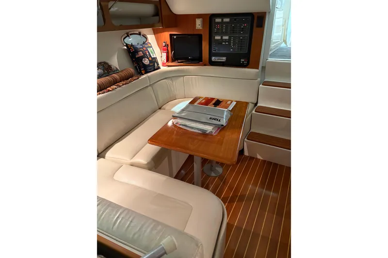 Slide: The Image of 1994 Tiara Yachts 3100 Open interior with wood flooring and seating area. - 28