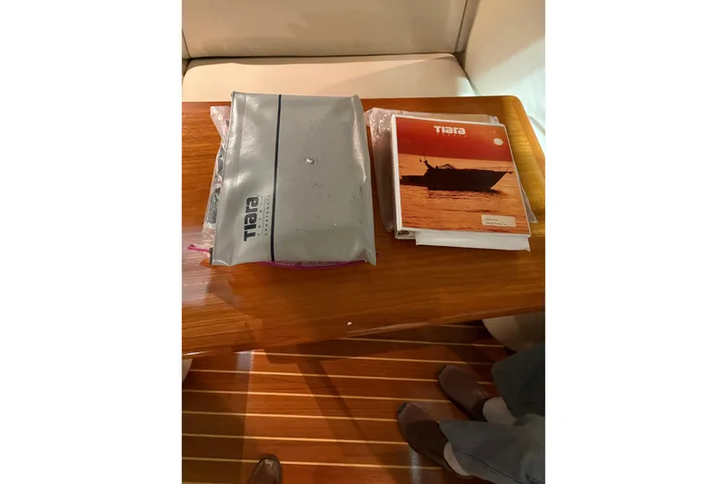 Slide: The Image of 1994 Tiara Yachts 3100 Open cabin interior with seating, table, and control panel. - 32