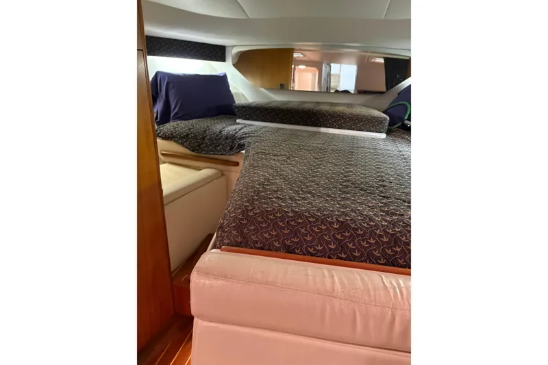 Slide: The Image of Interior of 1994 Tiara Yachts 3100 Open with cozy seating and nautical-themed pillows. - 33