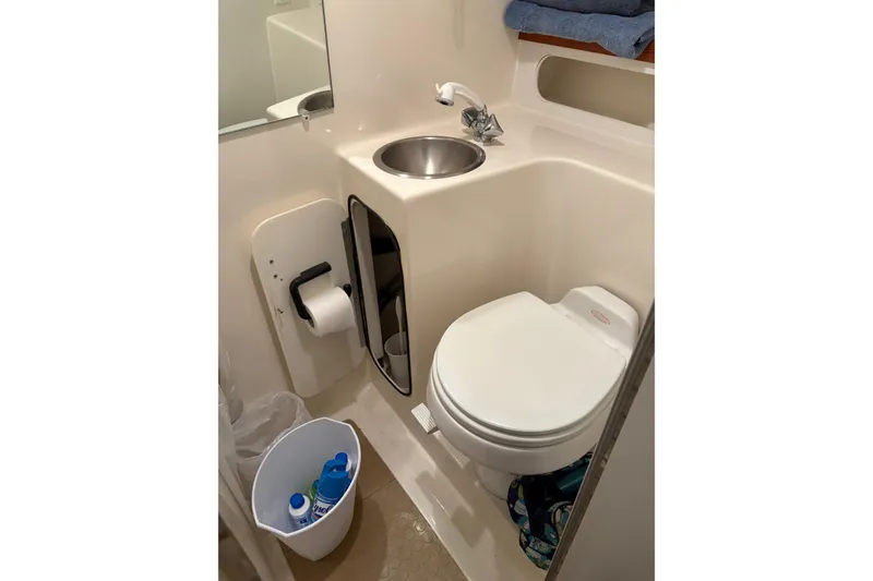 Slide: The Image of 1994 Tiara Yachts 3100 Open cabin interior with cozy bedding and wooden accents. - 37