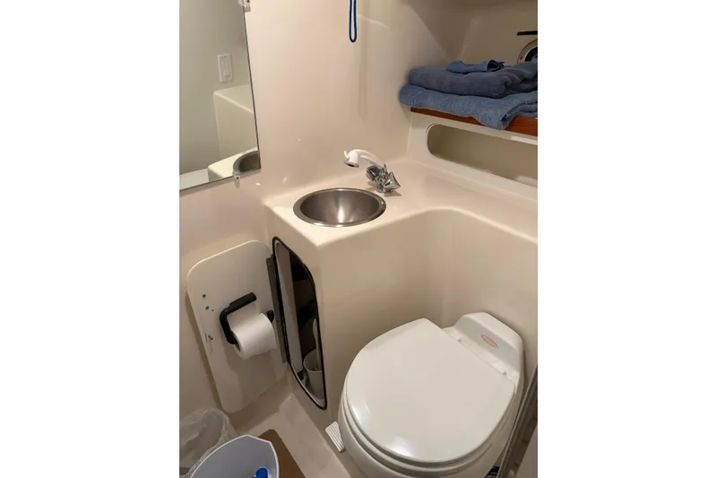 Slide: The Image of 1994 Tiara Yachts 3100 Open interior with wooden cabinetry and compact sink area. - 38