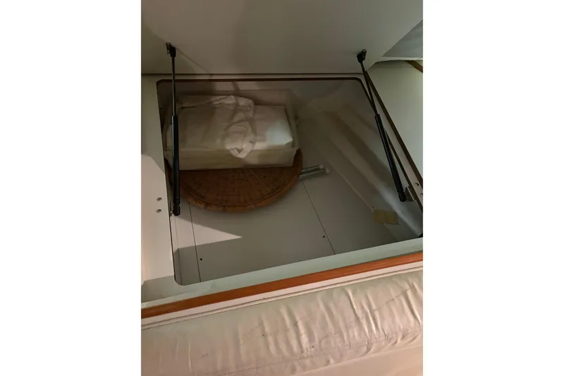 Slide: The Image of 1994 Tiara Yachts 3100 Open interior with kitchenette, featuring fridge, microwave, and fire extinguisher. - 39