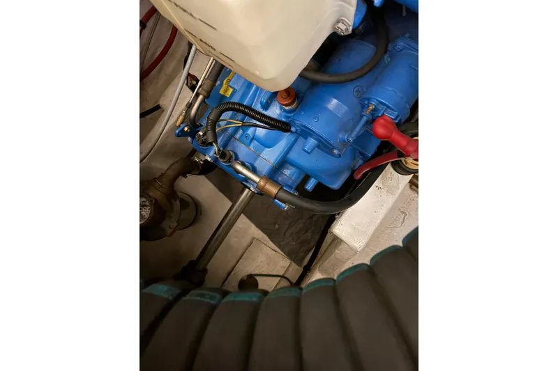 Slide: The Image of Engine of a 1994 Tiara Yachts 3100 Open, featuring blue components and black hoses. - 46