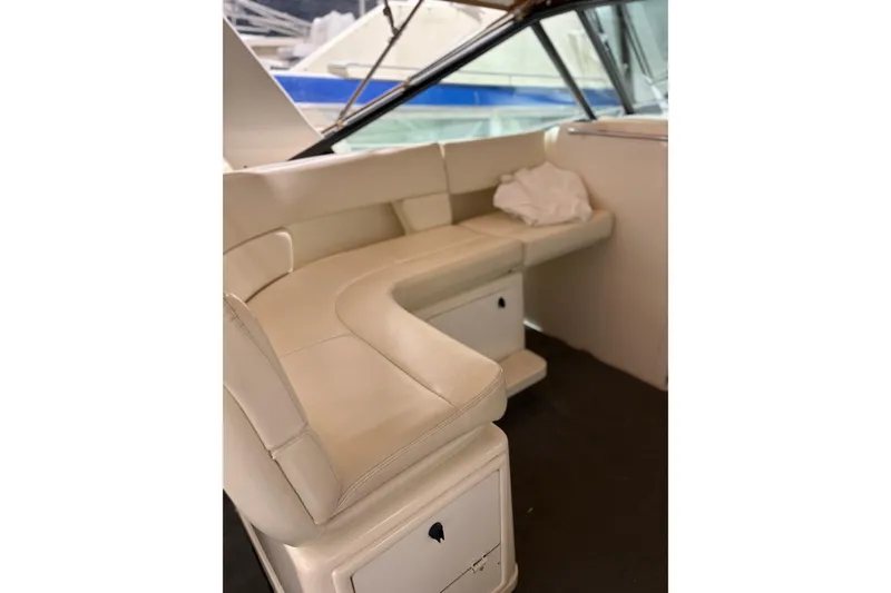 Slide: The Image of 1994 Tiara Yachts 3100 Open boat interior with seating and protective cover. - 5