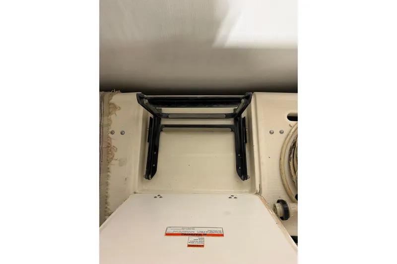 Slide: The Image of Engine compartment of a 1994 Tiara Yachts 3100 Open, featuring blue engine components. - 50