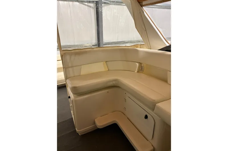 Slide: The Image of Cream leather seating on 1994 Tiara Yachts 3100 Open, featuring a built-in speaker. - 6