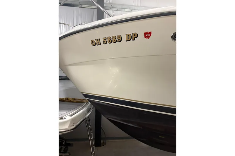 Slide: The Image of Interior cabin of 1994 Tiara Yachts 3100 Open, featuring patterned bedding and cozy seating. - 63