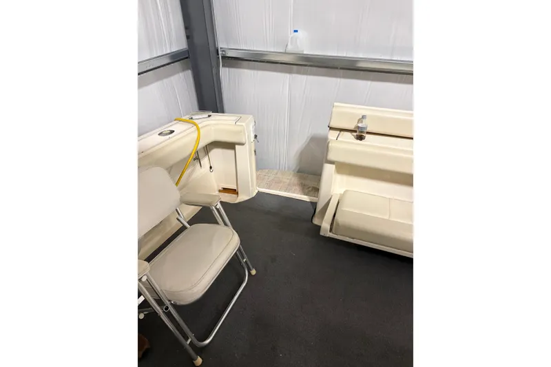 Slide: The Image of 1994 Tiara Yachts 3100 Open interior with cream leather seating and storage. - 9