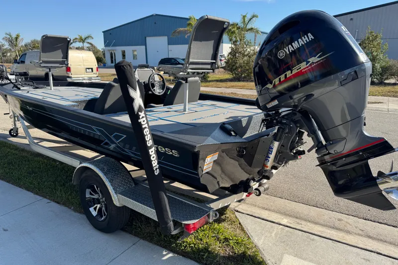 Slide: The Image of 2025 Express H20 boat with Yamaha VMAX engine on a trailer, parked outdoors. - 10