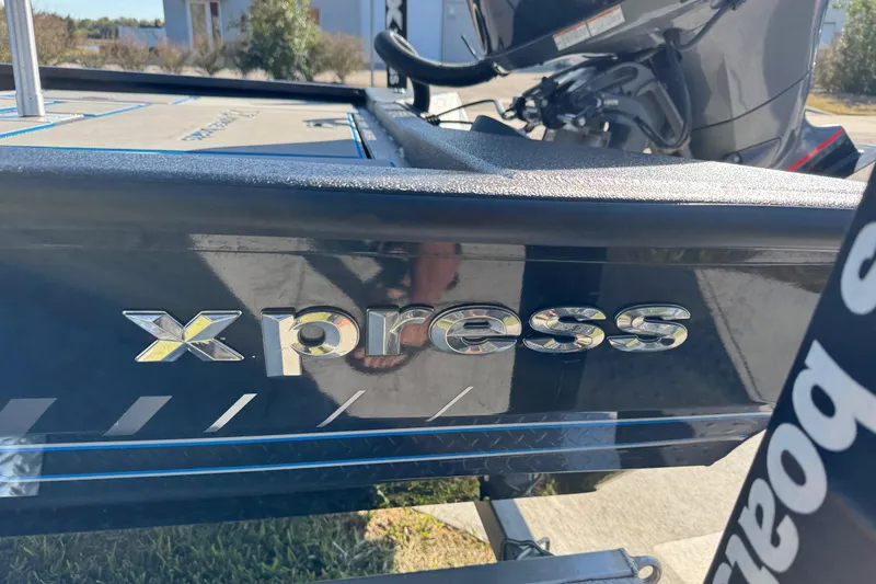 Slide: The Image of 2025 Express H20 boat with metallic logo, outdoor setting. - 12