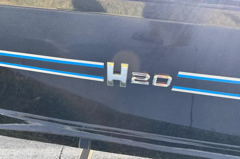 Slide: The Image of 2025 Express H20 vehicle emblem with blue and white stripes on a dark surface. - 13