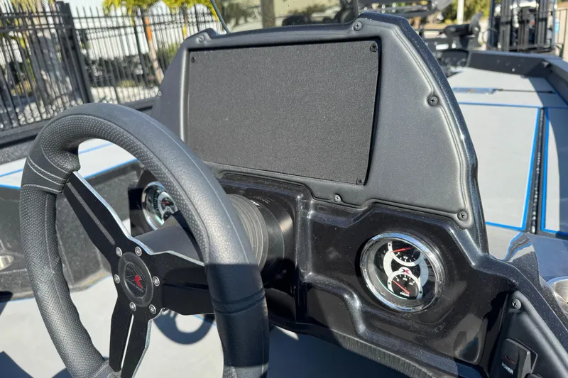 Slide: The Image of Steering wheel and dashboard of 2025 Express H20 boat, featuring modern gauges. - 20