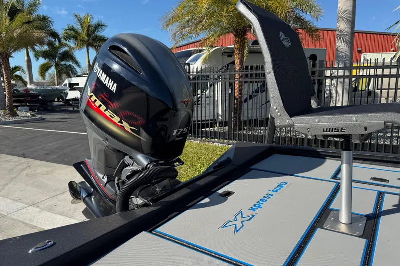 Slide: The Image of 2025 Express H20 boat with Yamaha VMAX 175 engine and Wise seat, parked near palm trees. - 23