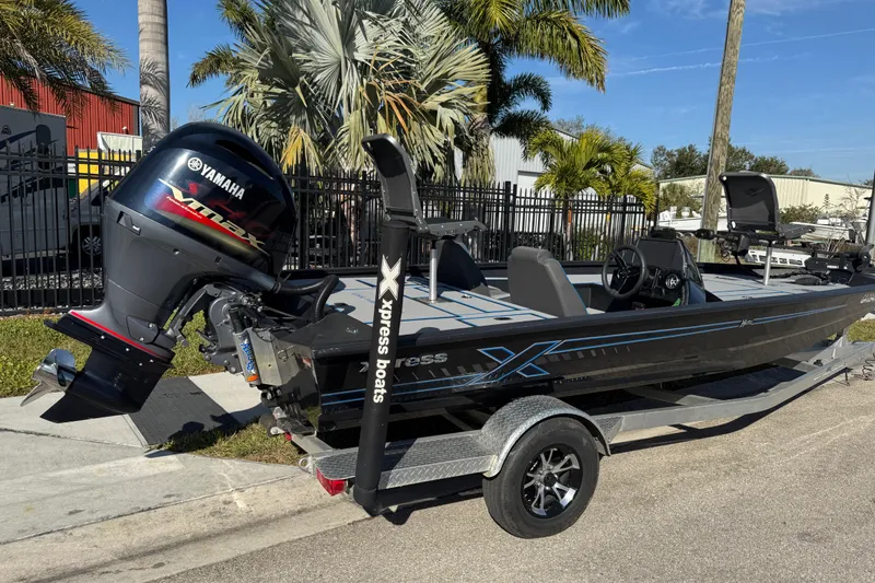 Slide: The Image of 2025 Express H20 boat with Yamaha VMAX engine, parked on a trailer near palm trees. - 3