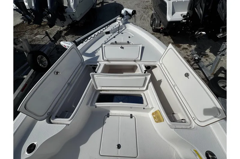 Slide: The Image of 2021 Blue Wave 2600 PureBay boat with open storage compartments on deck. - 13