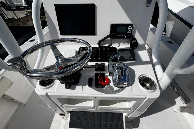 Slide: The Image of 2021 Blue Wave 2600 PureBay boat console with steering wheel and controls. - 15