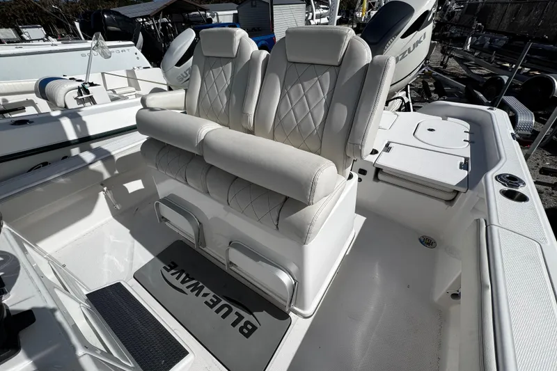 Slide: The Image of 2021 Blue Wave 2600 PureBay boat interior with dual cushioned seats and storage compartments. - 17