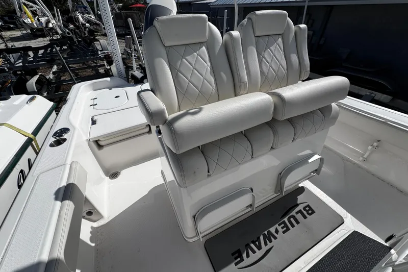Slide: The Image of 2021 Blue Wave 2600 PureBay boat interior with white cushioned seating. - 18