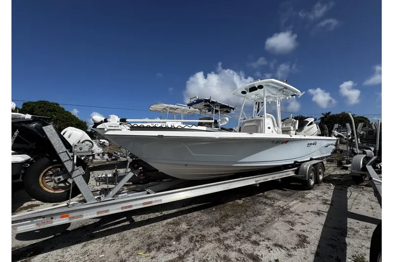 The Image of 2021 Blue Wave 2600 PureBay boat on trailer under clear blue sky. - 2