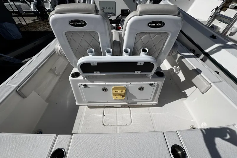 Slide: The Image of 2021 Blue Wave 2600 PureBay boat interior with dual seats and storage compartments. - 21