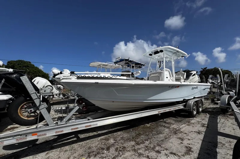 Slide: The Image of 2021 Blue Wave 2600 PureBay boat on trailer under clear blue sky. - 22