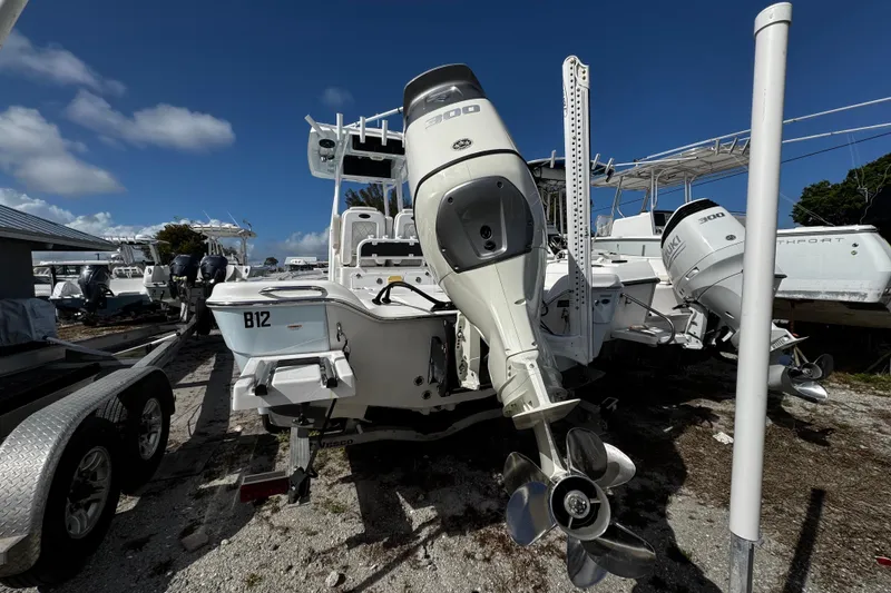 Slide: The Image of 2021 Blue Wave 2600 PureBay boat with dual outboard motors on a trailer. - 24