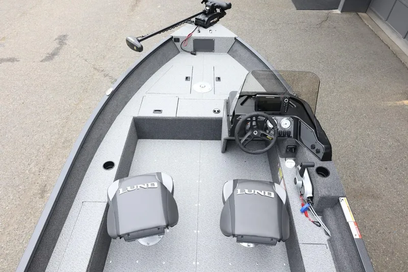 Slide: The Image of 2026 Lund 1650 Angler SS boat interior with steering console and seating. - 10