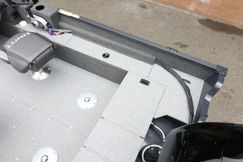 Slide: The Image of 2026 Lund 1650 Angler SS boat interior with seating and storage compartments. - 12