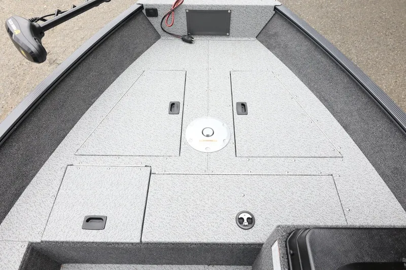 Slide: The Image of 2026 Lund 1650 Angler SS boat interior with storage compartments and trolling motor. - 13